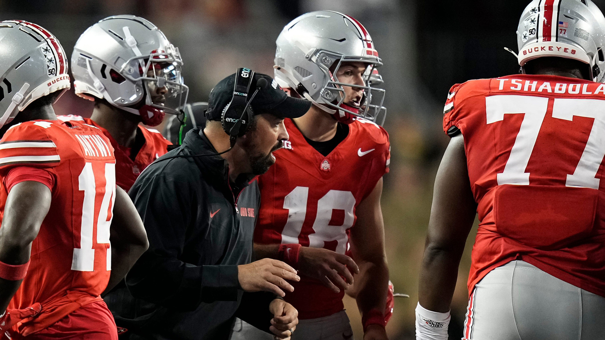 Ohio State Buckeyes head coach Ryan Day talks to quarterback Will Howard (18) in the huddle during the second half of the NCAA football game against the Western Michigan Broncos at Ohio Stadium.