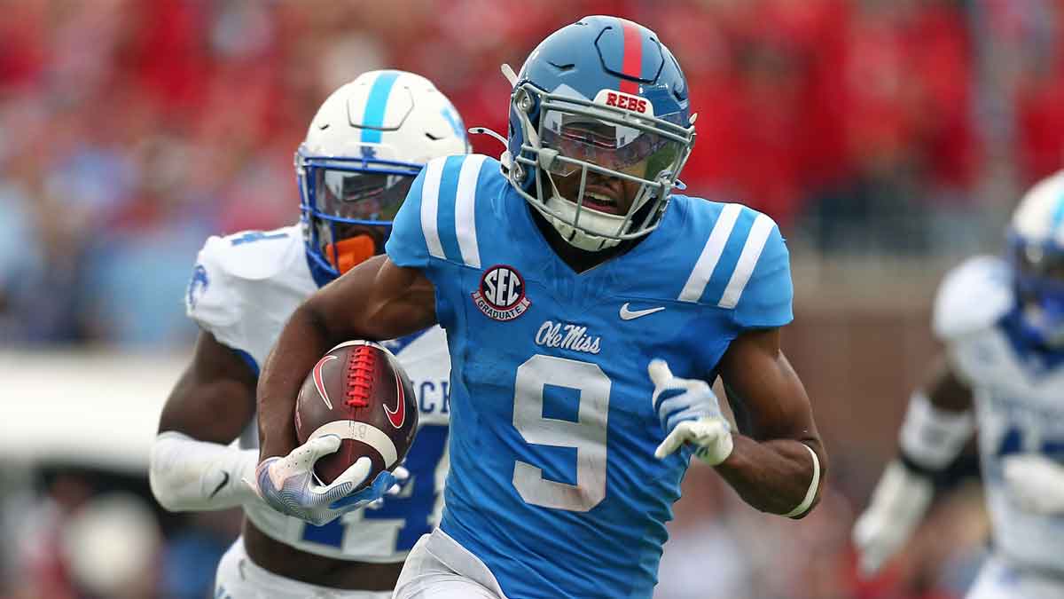 Ole Miss football wide receiver Tre Harris (9) runs after a catch for a first down as Kentucky Wildcats defensive back Jordan Lovett (25) pursues during the second half at Vaught-Hemingway Stadium.