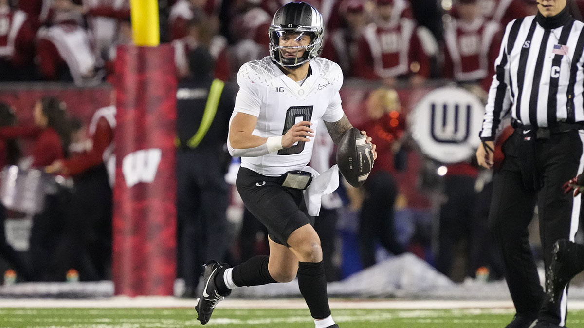 Oregon Ducks quarterback Dillon Gabriel (8) looks to throw a pass during the third quarter against the Wisconsin Badgers at Camp Randall Stadium.