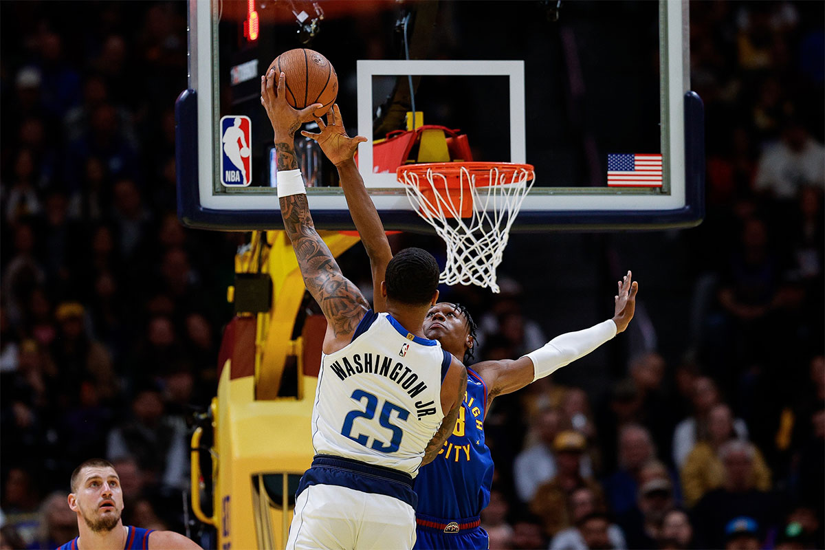 Dallas Mavericks forward P.J. Washington Jr. (25) drives to the basket against Denver Nuggets forward Peyton Watson (8) in the first quarter at Ball Arena.