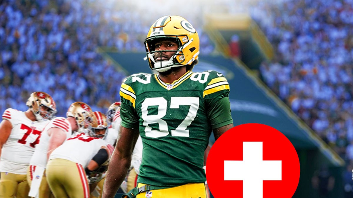 Packers Romeo Doubs next to a red cross
