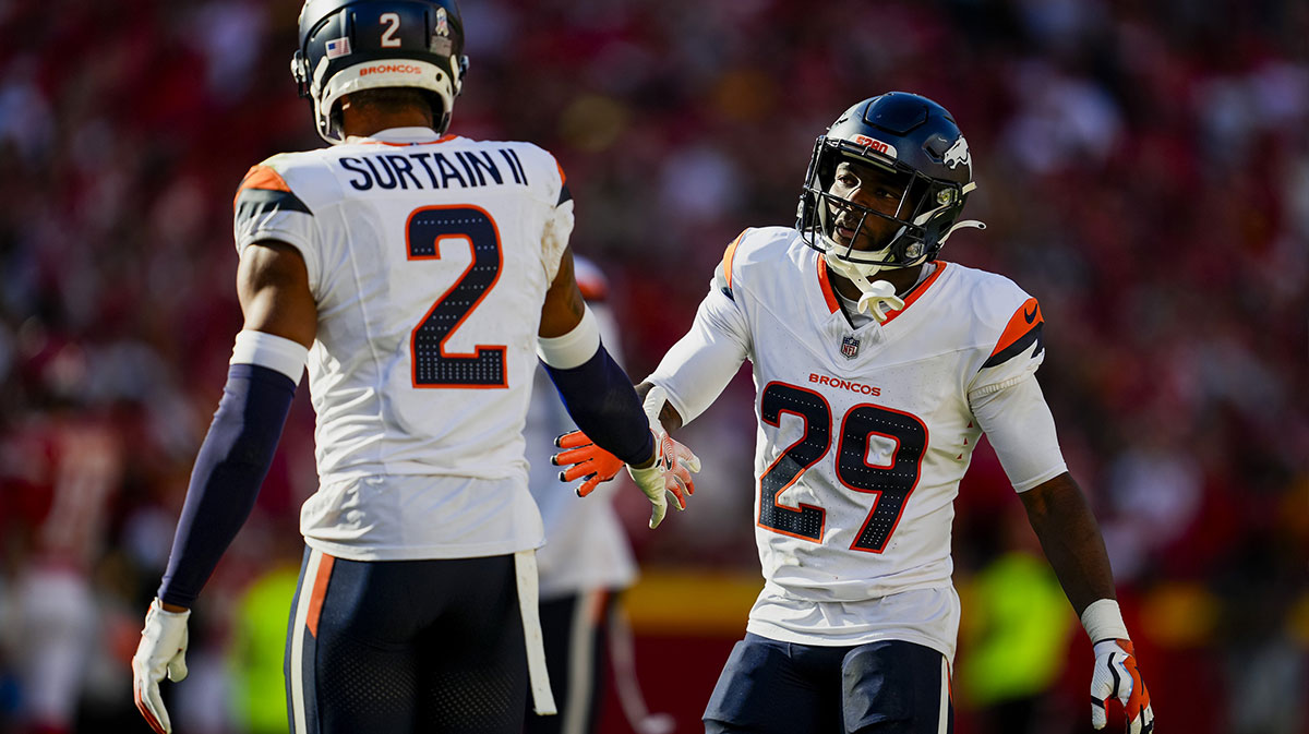 Denver Broncos cornerback Ja'Quan McMillian (29) celebrates with cornerback Pat Surtain II (2) after a play during the second half against the Kansas City Chiefs at GEHA Field at Arrowhead Stadium.