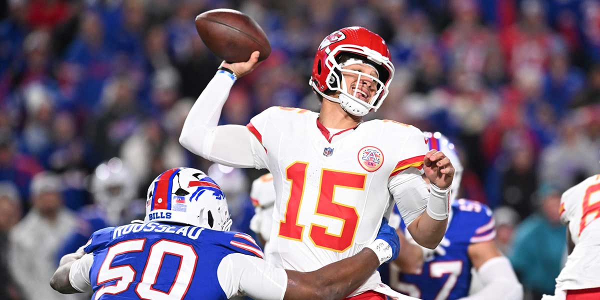 Kansas City Chiefs quarterback Patrick Mahomes (15) is pressured by Buffalo Bills defensive end Greg Rousseau (50) in the second quarter at Highmark Stadium.