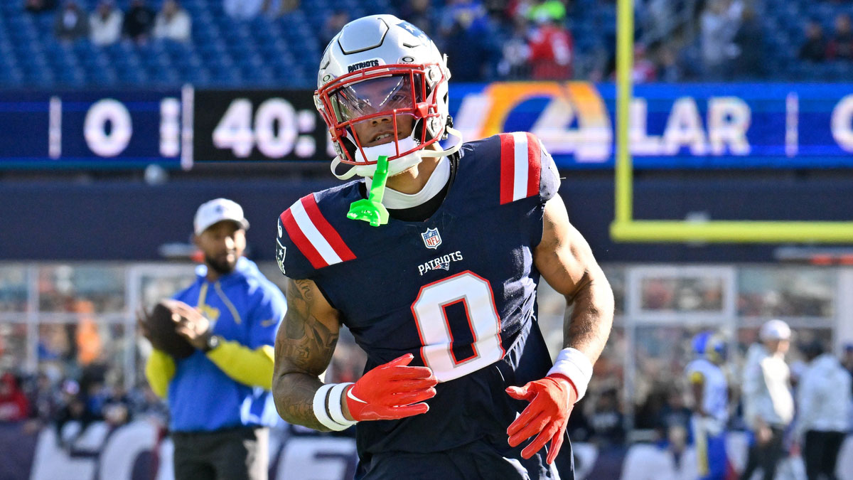 Patriots cornerback Christian Gonzalez (0) warms up before a game against the Los Angeles Rams at Gillette Stadium