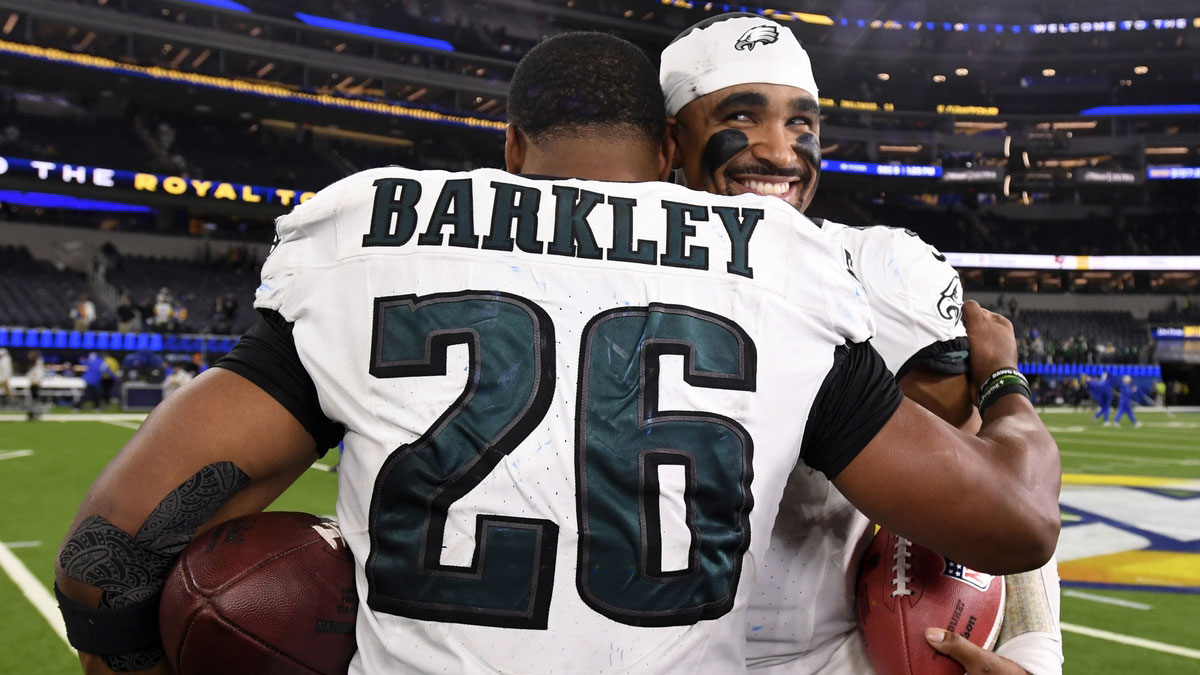 Philadelphia Eagles quarterback Jalen Hurts (1) hugs running back Saquon Barkley (26) in celebration after the Eagles defeat the Los Angeles Rams during the first half at SoFi Stadium.