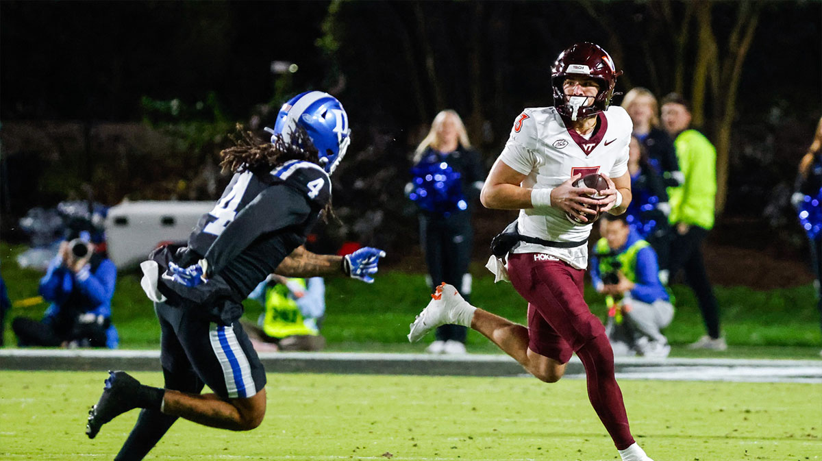 Virginia Tech Hokies quarterback Collin Schlee (3) runs with the football chased by Duke Blue Devils linebacker Cameron Bergeron (4) during the second half of the game against Duke Blue Devils at Wallace Wade Stadium.