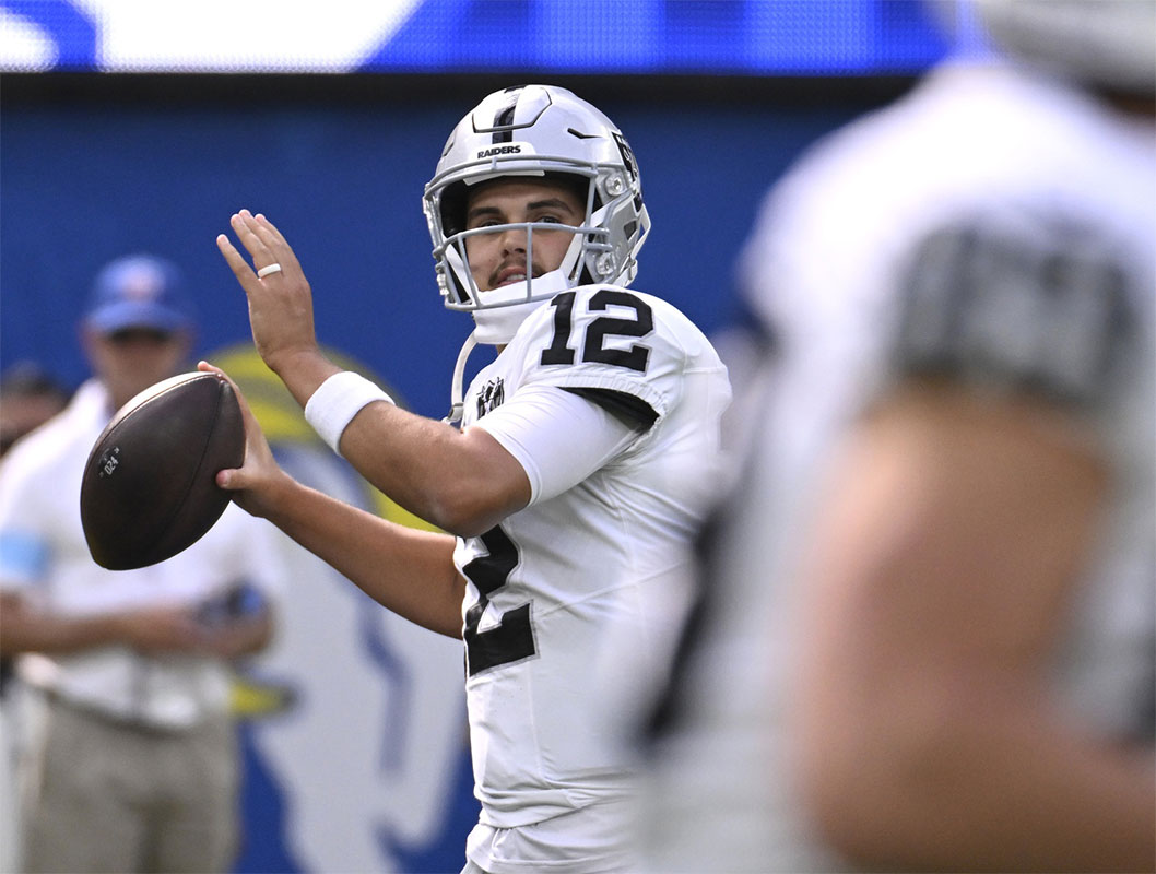 Las Vegas Raiders quarterback Aidan O'Connell (12) throws a pass during warmups before the game against the Los Angeles Rams at SoFi Stadium. 