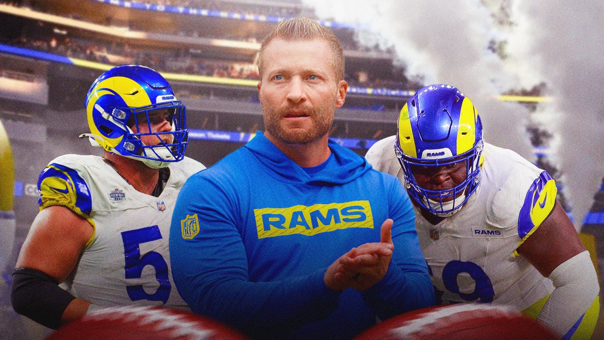 Sean McVay next to Beaux Limmer and Jonah Jackson in front of a Rams motif