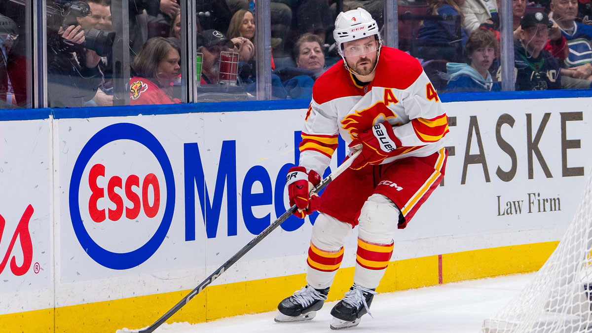 Calgary Flames defenseman Rasmus Andersson (4) handles the puck against the Vancouver Canucks during the third period at Rogers Arena.
