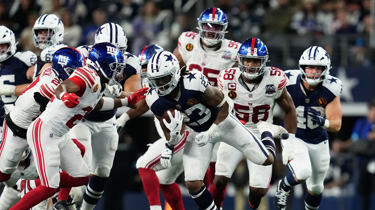 Dallas Cowboys running back Rico Dowdle (23) runs the ball as New York Giants running back Eric Gray (20) defends during the second half at AT&T Stadium. 