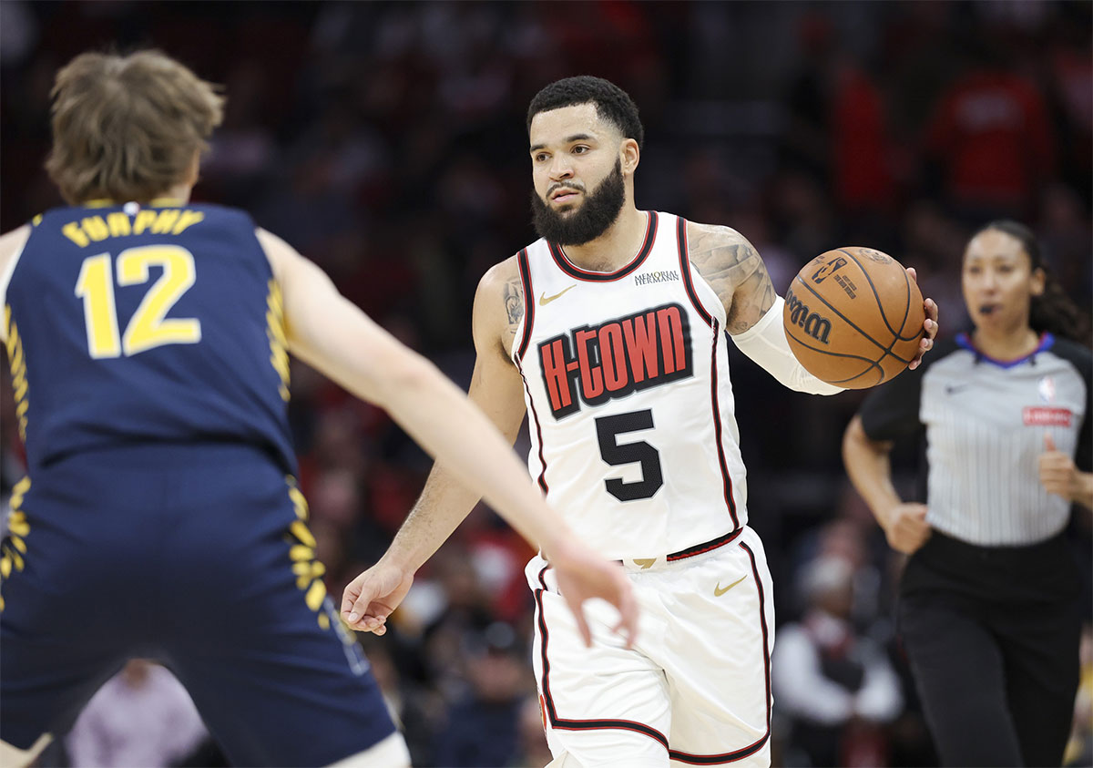 Houston Rockets guard Fred VanVleet (5) brings the ball up the court as Indiana Pacers forward Johnny Furphy (12) defends during the first quarter at Toyota Center.