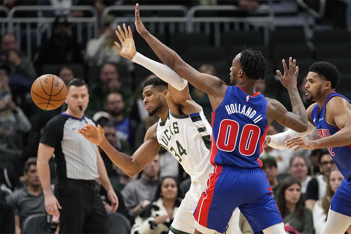 Detroit Pistons forward Ron Holland II (00) knocks the ball away from Milwaukee Bucks forward Giannis Antetokounmpo (34) in the third quarter at Fiserv Forum. 