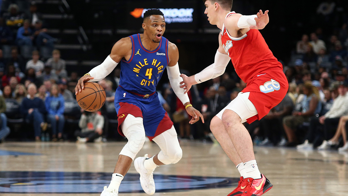 Denver Nuggets guard Russell Westbrook (4) dribbles as Memphis Grizzlies forward Jake LaRavia (3) defends during the first half at FedExForum.