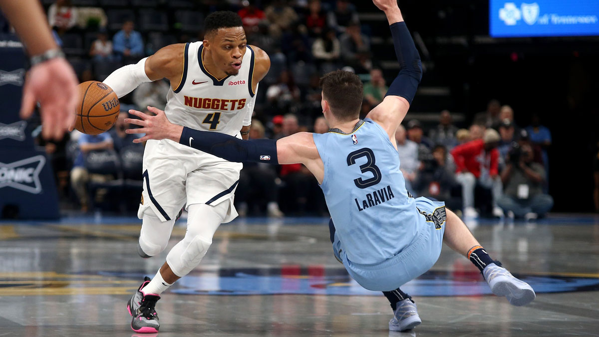 Denver Nuggets guard Russell Westbrook (4) drives to the basket as Memphis Grizzlies forward Jake LaRavia (3) falls during the first half at FedExForum.
