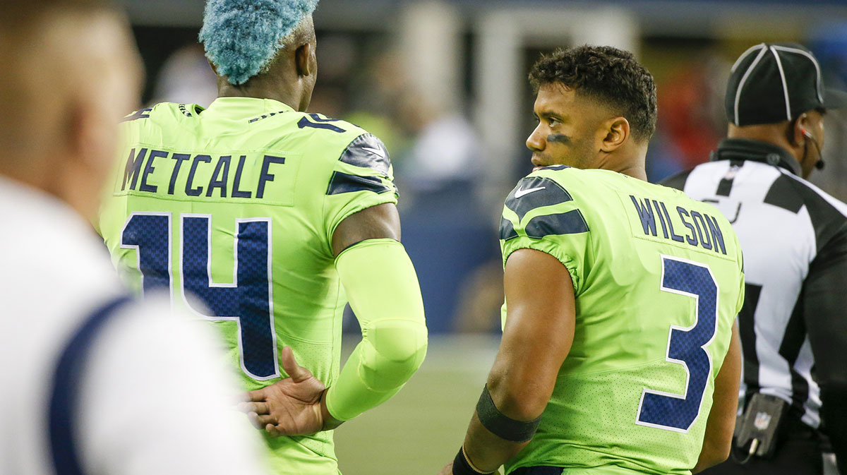 Seattle Seahawks quarterback Russell Wilson (3) talks with wide receiver DK Metcalf (14) during the fourth quarter against the Los Angeles Rams at Lumen Field. 