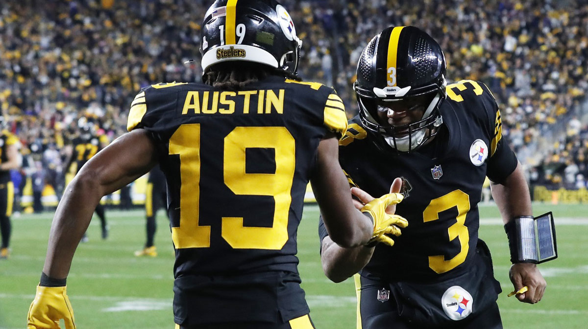 Pittsburgh Steelers wide receiver Calvin Austin III (19) and quarterback Russell Wilson (3) celebrate after combining for a touchdown against the during the fourth quarter at Acrisure Stadium.