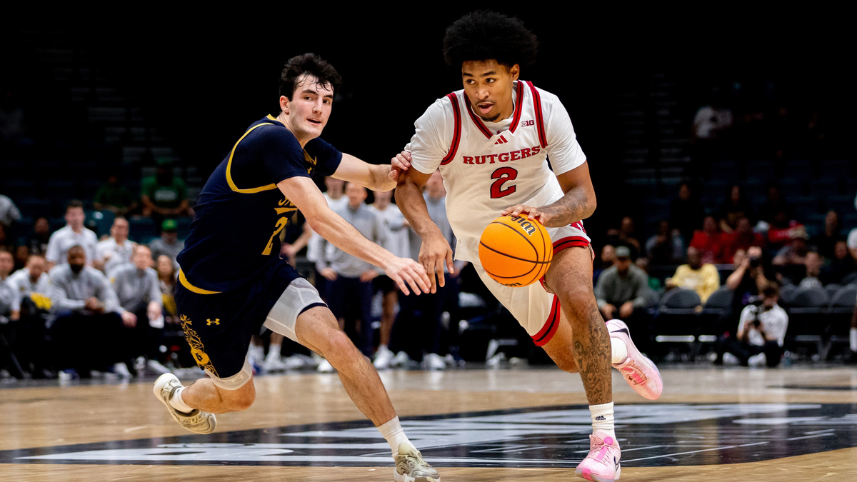 Rutgers Scarlet Knights guard Dylan Harper (2) drives past Notre Dame Fighting Irish guard Logan Imes during overtime at MGM Grand Garden Arena.