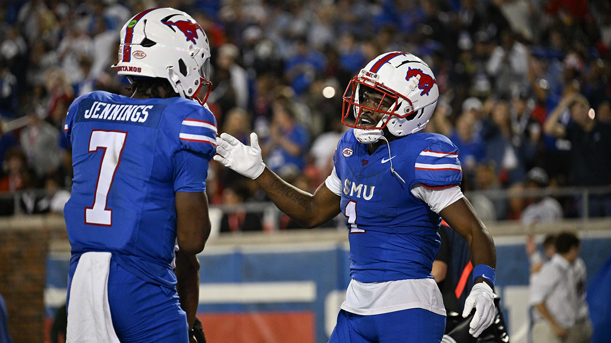 Southern Methodist Mustangs quarterback Kevin Jennings (7) and running back Brashard Smith (1) celebrate a touchdown against the Pittsburgh Panthers during the first half at Gerald J. Ford Stadium.