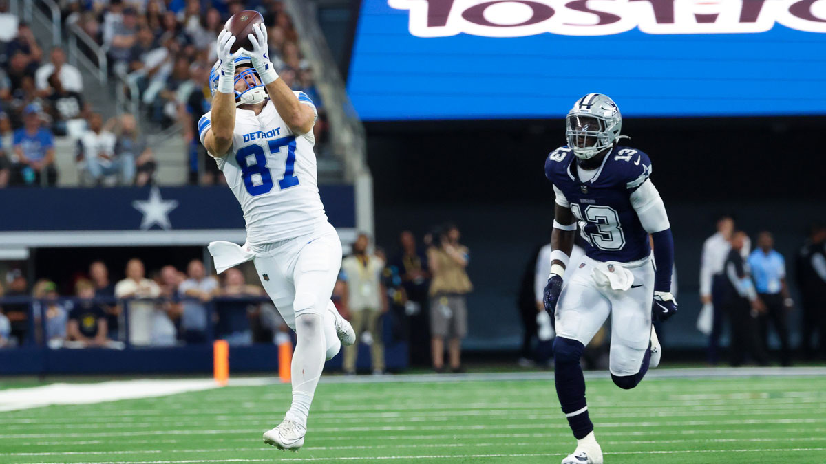 Detroit Lions tight end Sam LaPorta (87) catches a pass past Dallas Cowboys linebacker DeMarvion Overshown (13) and scores a touchdown during the second quarter at AT&T Stadium.