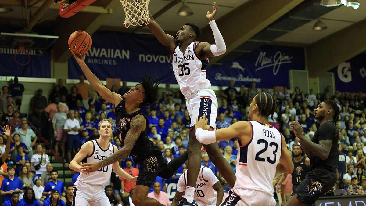 Memphis Tigers guard PJ Haggerty (4) tries for the basket while being guarded by Connecticut Huskies center Samson Johnson (35) in the second half of an NCAA college basketball game at Lahaina Civic Center