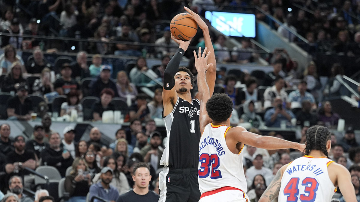  San Antonio Spurs center Victor Wembanyama (1) shoots over Golden State Warriors forward Trayce Jackson-Davis (32) in the second half at Frost Bank Center.