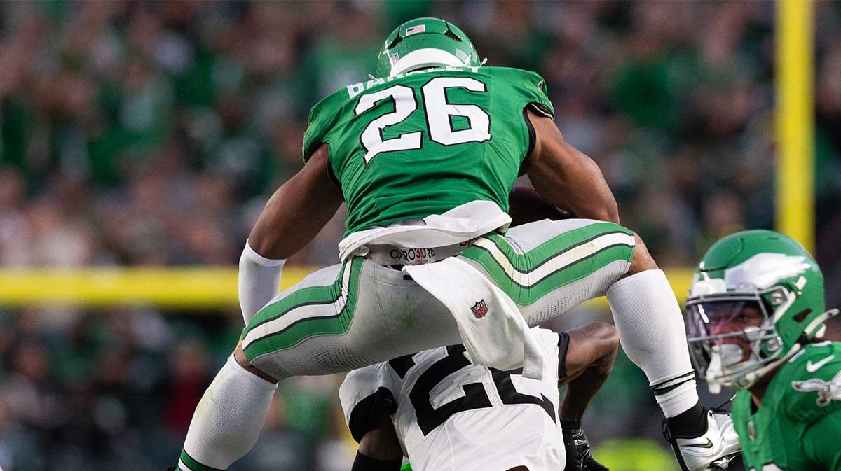 Philadelphia Eagles running back Saquon Barkley (26) leaps with the ball over Jacksonville Jaguars cornerback Jarrian Jones (22) during the second quarter at Lincoln Financial Field.