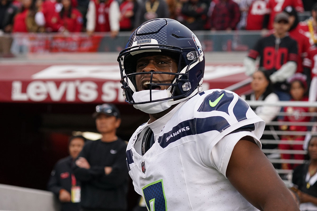 Seattle Seahawks quarterback Geno Smith (7) celebrates after scoring a rushing touchdown past San Francisco 49ers cornerback Isaac Yiadom (22) to win the game in the fourth quarter at Levi's Stadium.