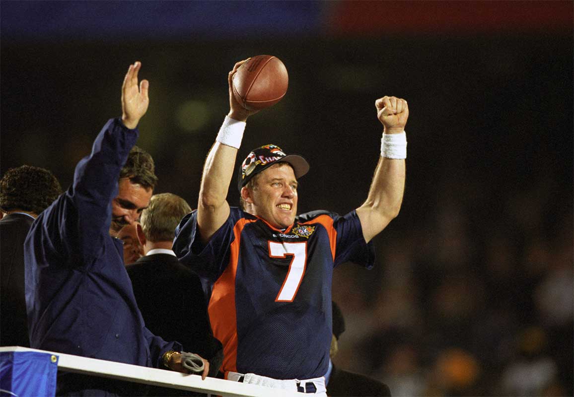 Jan 25, 1998; San Diego, CA, USA; FILE PHOTO; Denver Broncos head coach (left) Mike Shanahan and quarterback (7) John Elway celebrate the Broncos first Super Bowl title against the Green Bay Packers in Super Bowl XXXII at Qualcomm Stadium. The Broncos defeated the Packers 31-24. 