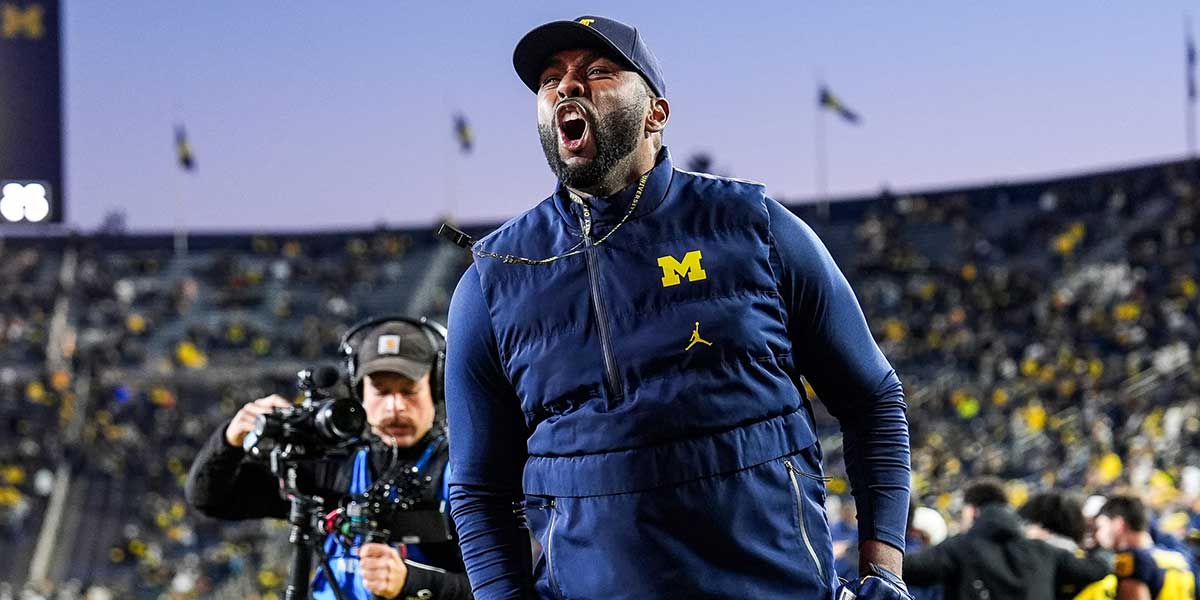 Michigan head coach Sherrone Moore cheers up fans before the Michigan State game at Michigan Stadium