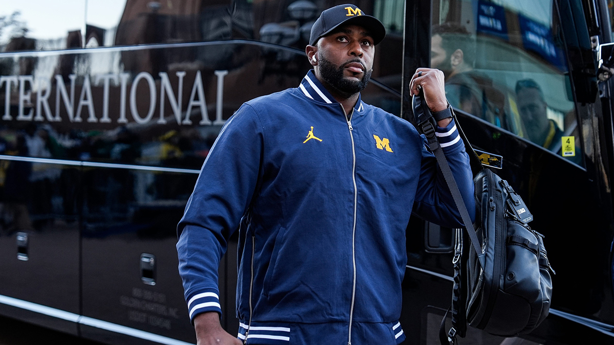 Michigan head coach Sherrone Moore walks off the bus during team arrival before the Michigan State game at Michigan Stadium