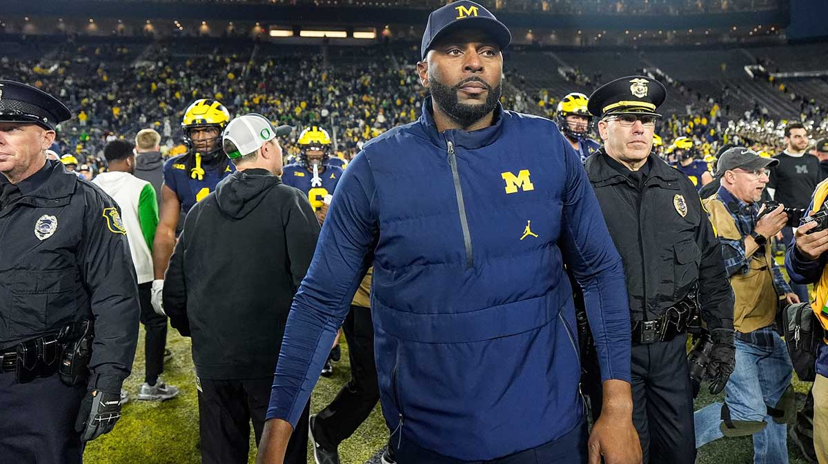 Michigan head coach Sherrone Moore walks off the field after 38-17 loss to Oregon at Michigan Stadium