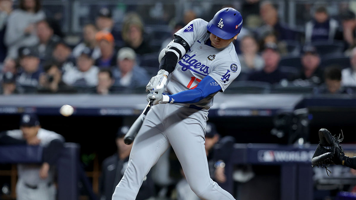 Los Angeles Dodgers two-way player Shohei Ohtani (17) hits a single during the fifth inning against the New York Yankees in game four of the 2024 MLB World Series at Yankee Stadium. 