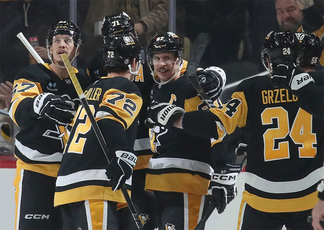 Pittsburgh Penguins center Sidney Crosby (87) is congratulated by teammates after scoring his 600th career NHL goal against the Utah Hockey Club during the second period at PPG Paints Arena.