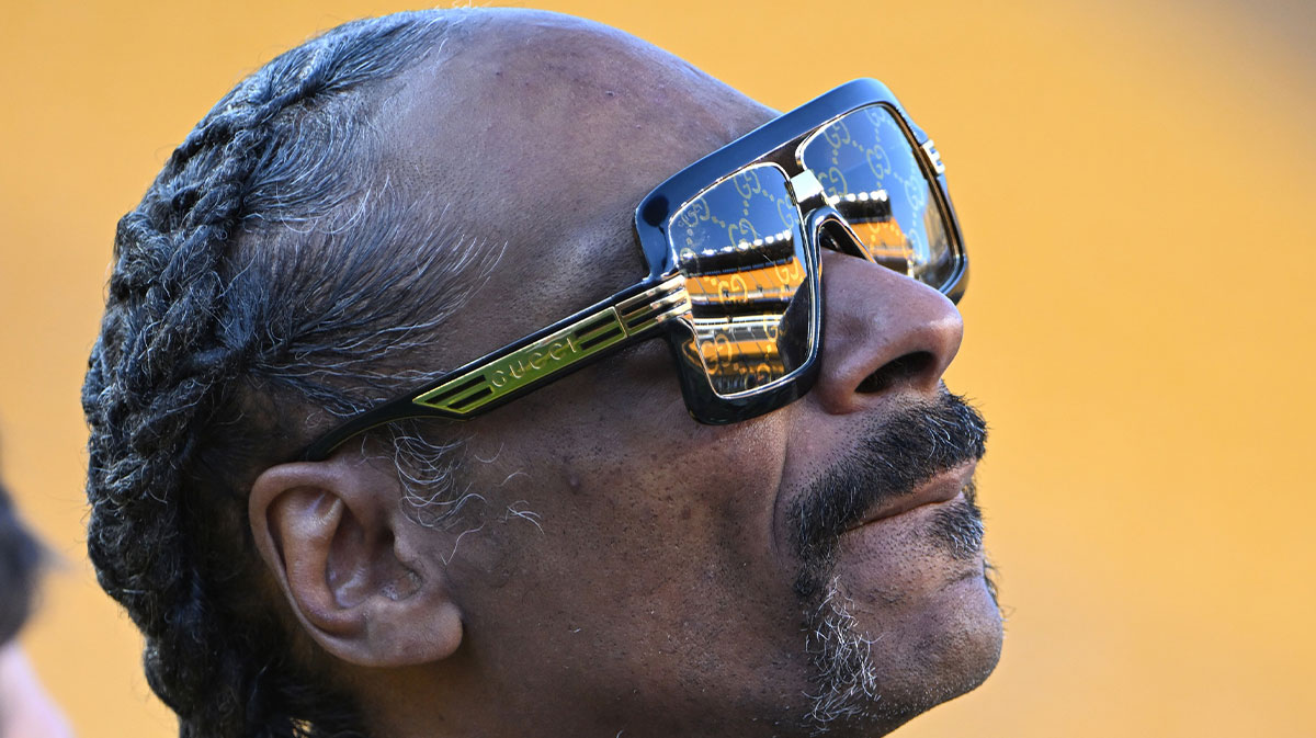 Snoop Dogg visits the field before a game between the Pittsburgh Steelers and the Dallas Cowboys. Snoop Dogg also attended USC women's basketball and their game against Notre Dame on Nov. 23, wearing a custom JuJu Watkins jacket.