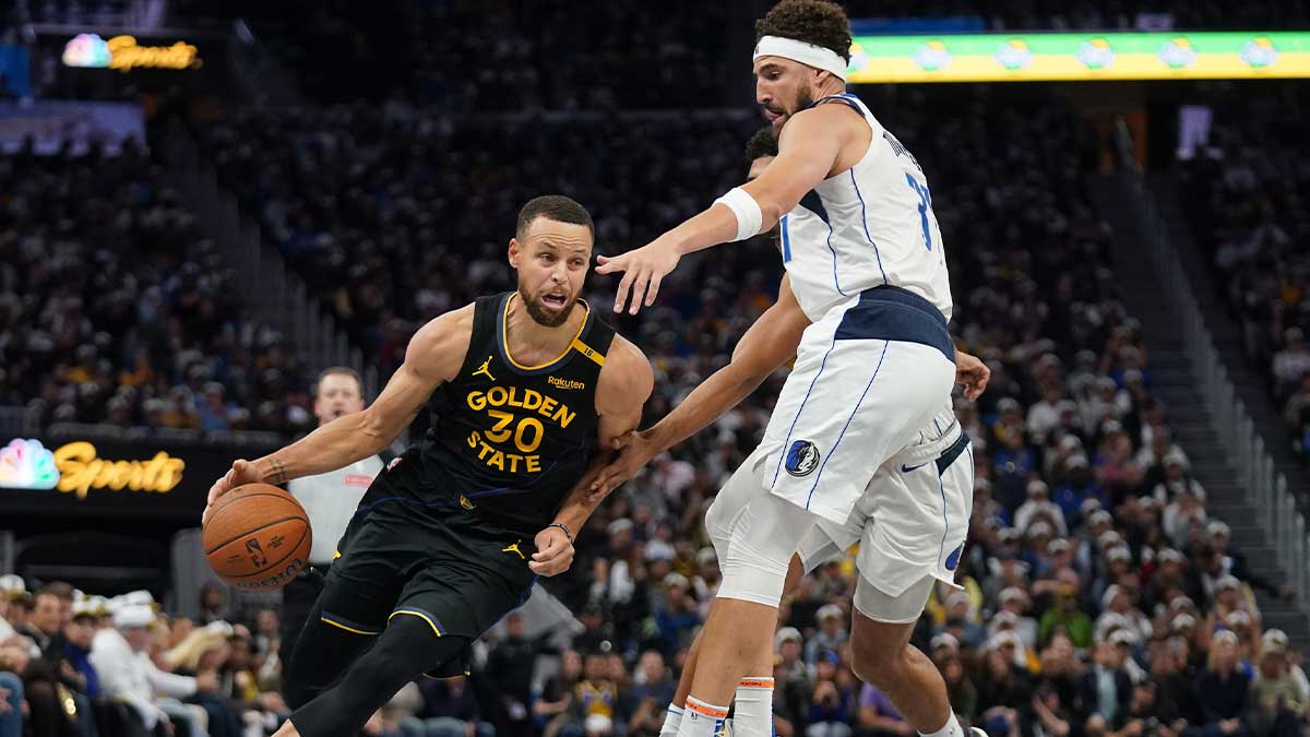 Golden State Warriors guard Stephen Curry (30) dribbles past Dallas Mavericks guard Klay Thompson (31) in the fourth quarter at the Chase Center. 