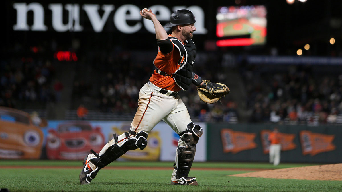 San Francisco Giants catcher Stephen Vogt (21) throws the ball to first during the ninth inning against the Cincinnati Reds at Oracle Park. 