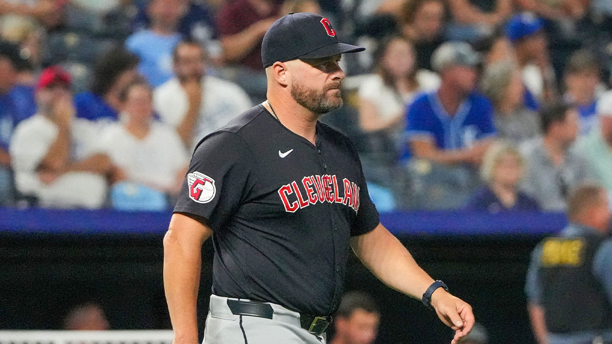 Cleveland Guardians manager Stephen Vogt (12) comes to the mound against the Kansas City Royals for a pitcher change in the seventh inning at Kauffman Stadium. 