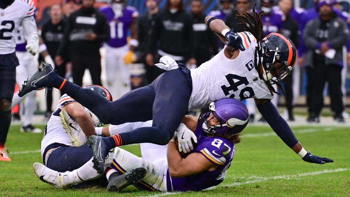 Minnesota Vikings tight end T.J. Hockenson (87) is tackled after a catch by Chicago Bears linebacker T.J. Edwards (53) and middle linebacker Tremaine Edmunds (49) during overtime at Soldier Field.