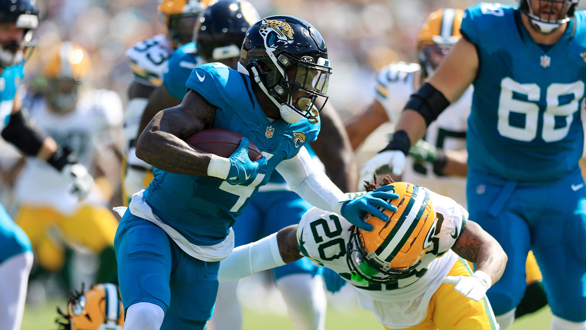 Jacksonville Jaguars running back Tank Bigsby (4) stiff arm Green Bay Packers safety Javon Bullard (20) during the second quarter of an NFL football matchup Sunday, Oct. 27, 2024 at EverBank Stadium in Jacksonville, Fla.