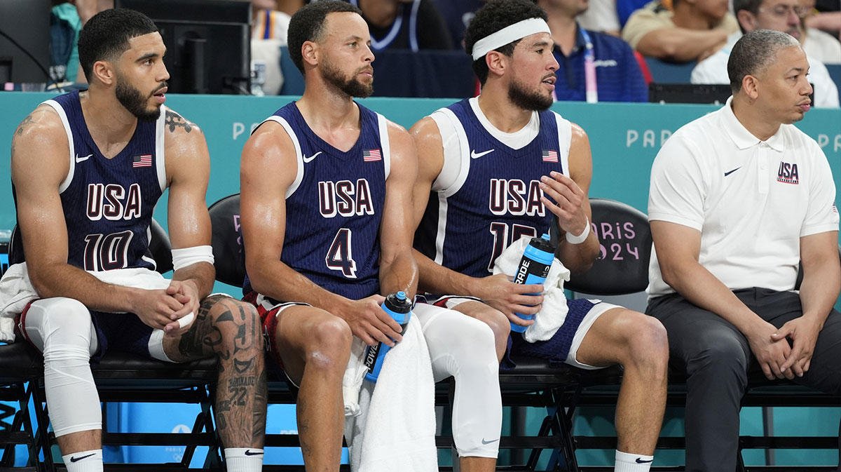 Aug 3, 2024; Villeneuve-d'Ascq, France; United States small forward Jayson Tatum of the Boston Celtics (10), shooting guard Stephen Curry (4), guard Devin Booker (15) and assistant coach Tyronn Lue on the bench in the third quarter against Puerto Rico during the Paris 2024 Olympic Summer Games at Stade Pierre-Mauroy. Mandatory Credit: John David Mercer-Imagn Images