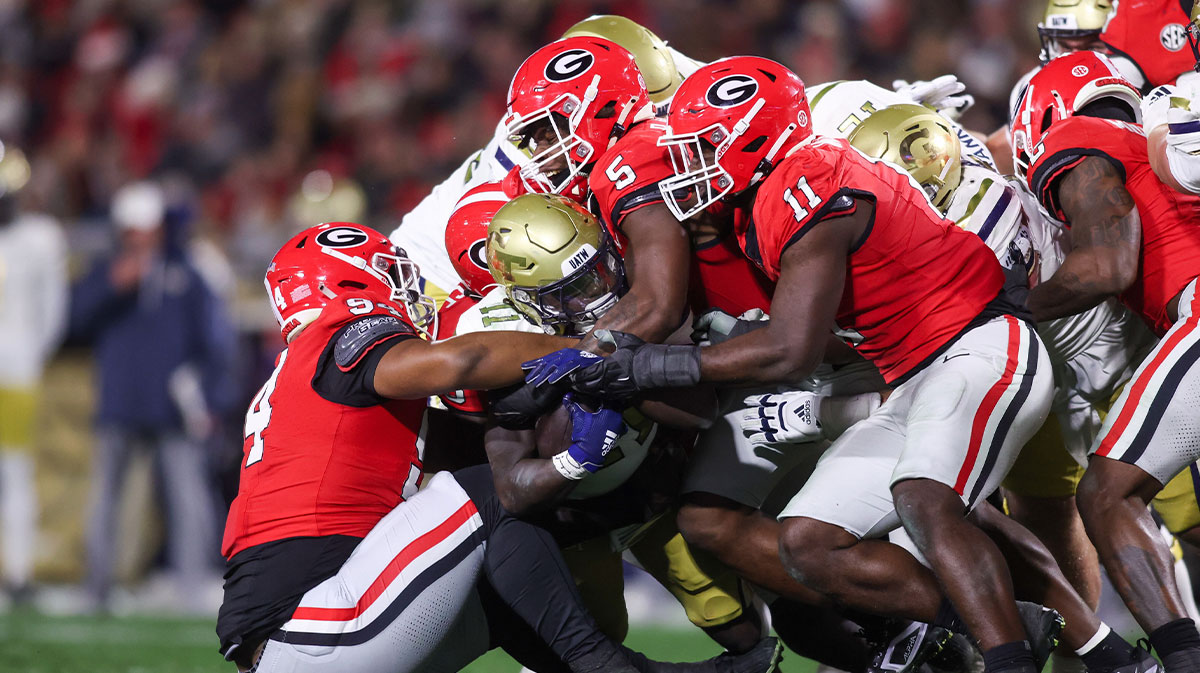 Georgia Tech Yellow Jackets running back Jamal Haynes (11) is tackled by Georgia Bulldogs defensive lineman Xzavier McLeod (94) and linebacker Raylen Wilson (5) and linebacker Jalon Walker (11) in the second quarter at Sanford Stadium.