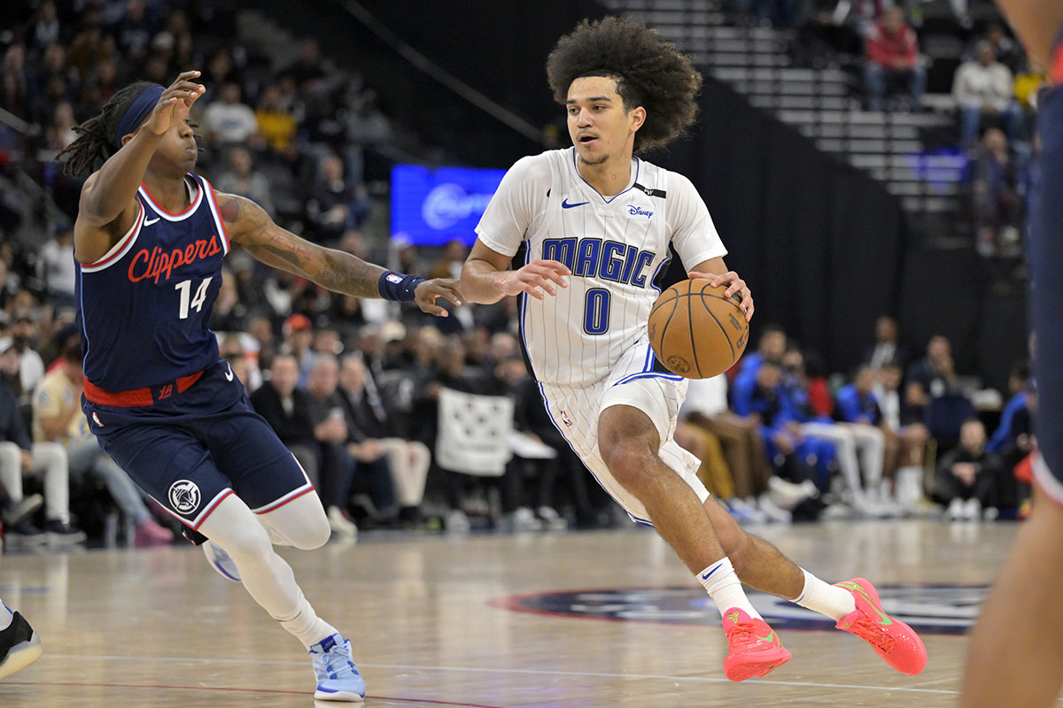 Los Angeles Clippers guard Terance Mann (14) defends Orlando Magic guard Anthony Black (0) in the second half at Intuit Dome.