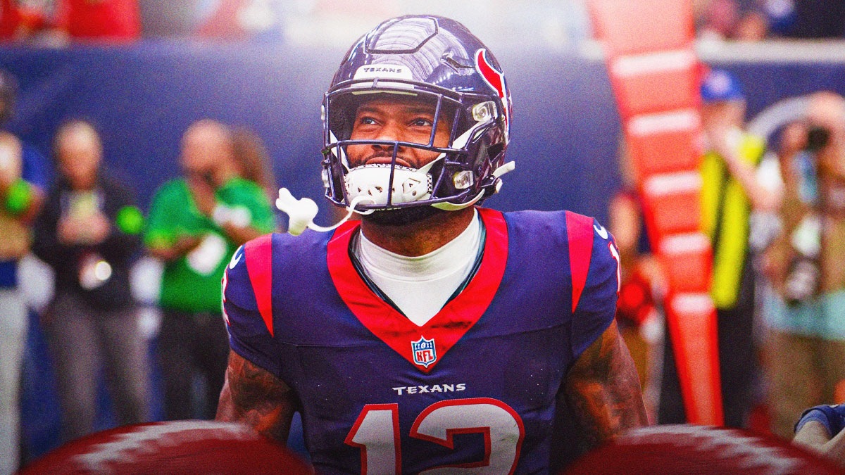 Nico Collins smiles in Texans gear