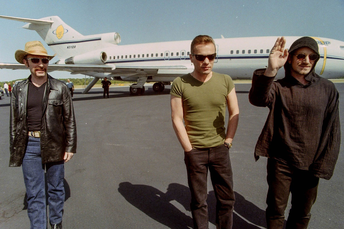 The Edge, Larry Mullen Jr., and Bono at the Anderson Regional Airport in 1997.