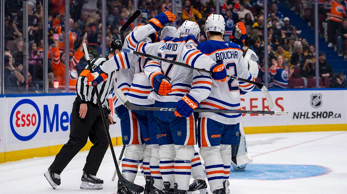 Edmonton Oilers forward Connor McDavid (97) celebrates with forward Zach Hyman (18) and defenseman Evan Bouchard (2) after scoring a goal against the Vancouver Canucks during the third period at Rogers Arena