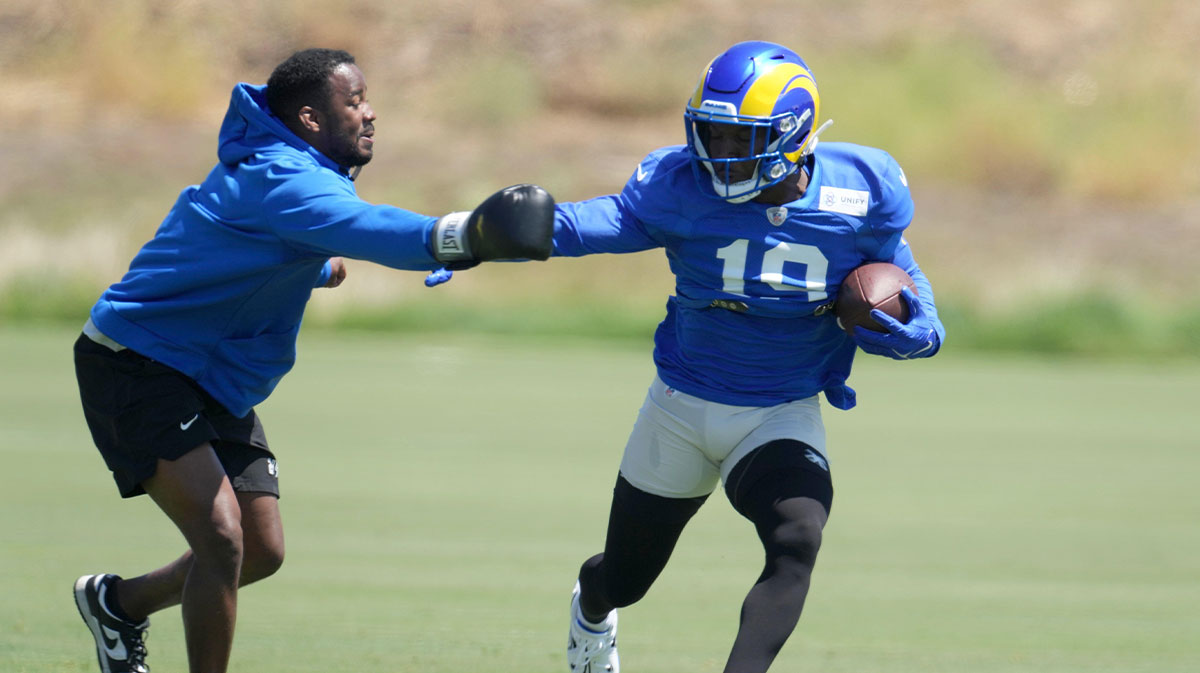 Los Angeles Rams receiver Brandon Powell (19) and tight ends coach Thomas Brown participate in drills during training camp at Cal Lutheran University.