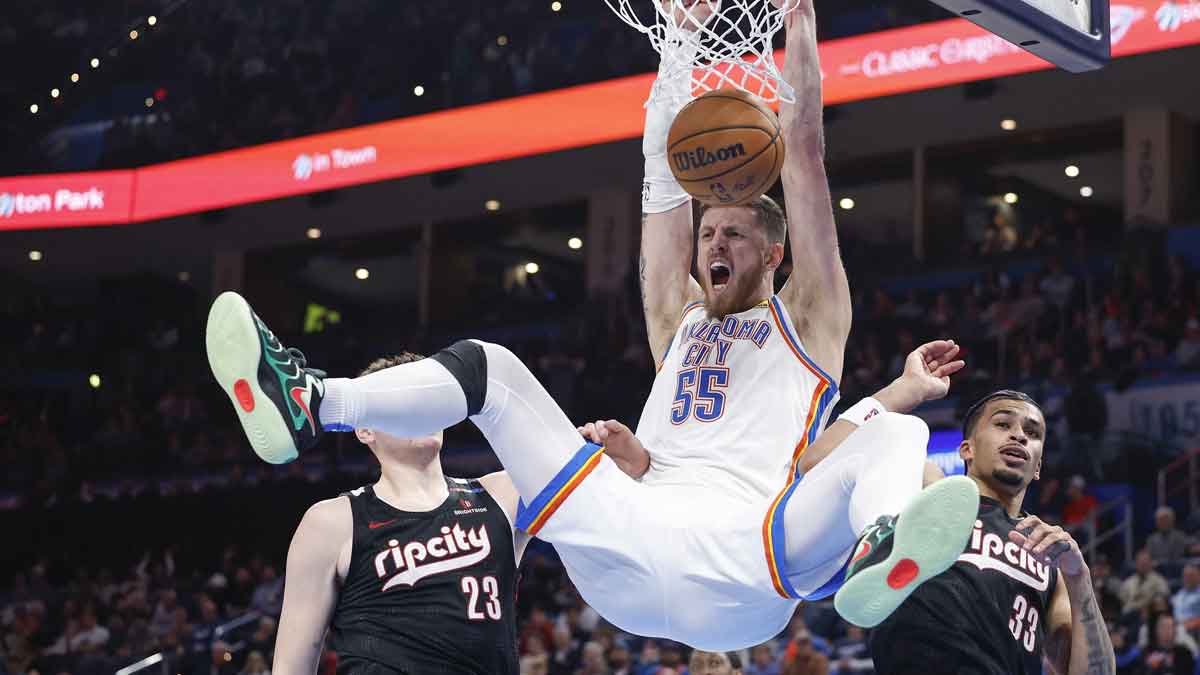 Thunder center Isaiah Hartenstein (55) celebrates a dunk between Portland Trail Blazers center Donovan Clingan (23) and forward Toumani Camara (33) during the second half at Paycom Center