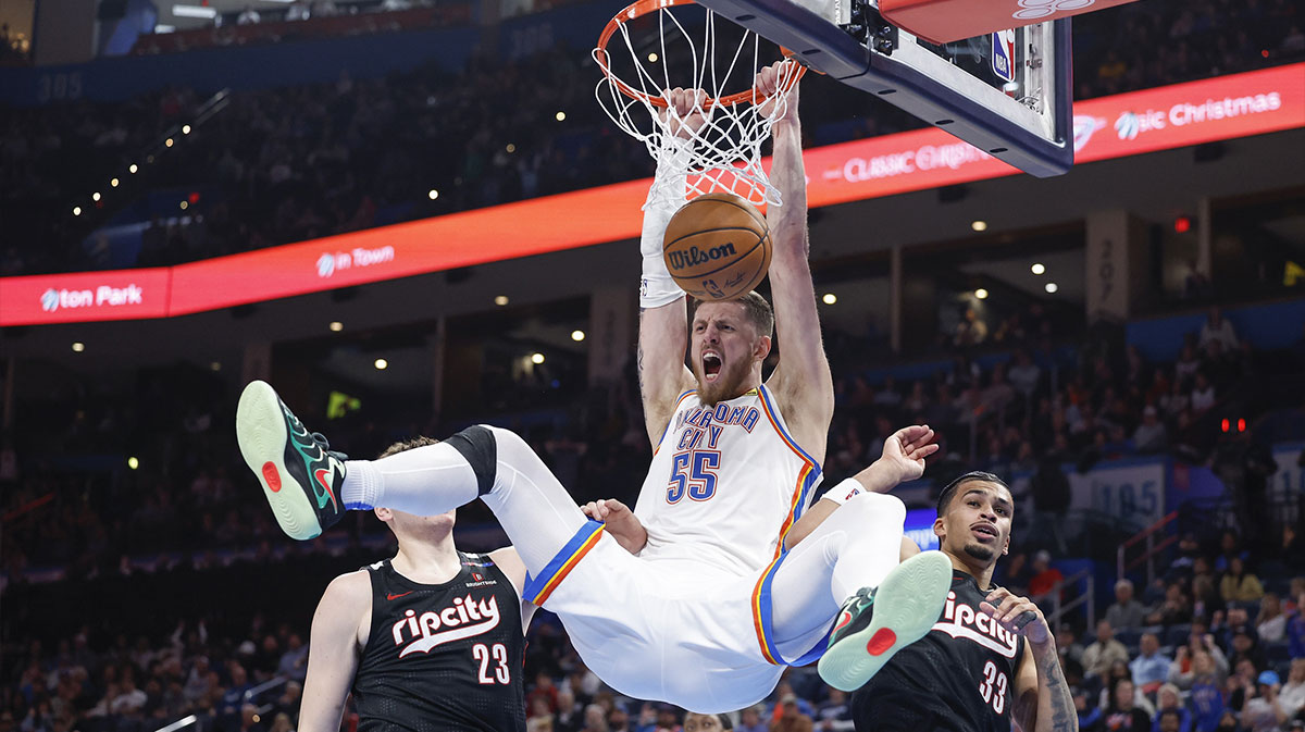 Thunder center Isaiah Hartenstein (55) celebrates a dunk between Portland Trail Blazers center Donovan Clingan (23) and forward Toumani Camara (33) during the second half at Paycom Center