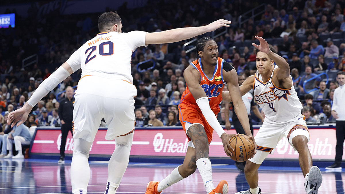 Thunder forward Jalen Williams (8) drives to the basket between Phoenix Suns center Oso Ighodaro (4) and center Jusuf Nurkic (20) during the fourth quarter at Paycom Center