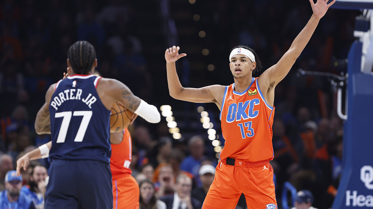 Thunder forward Ousmane Dieng (13) defends Los Angeles Clippers guard Kevin Porter Jr. (77) during the second quarter at Paycom Center